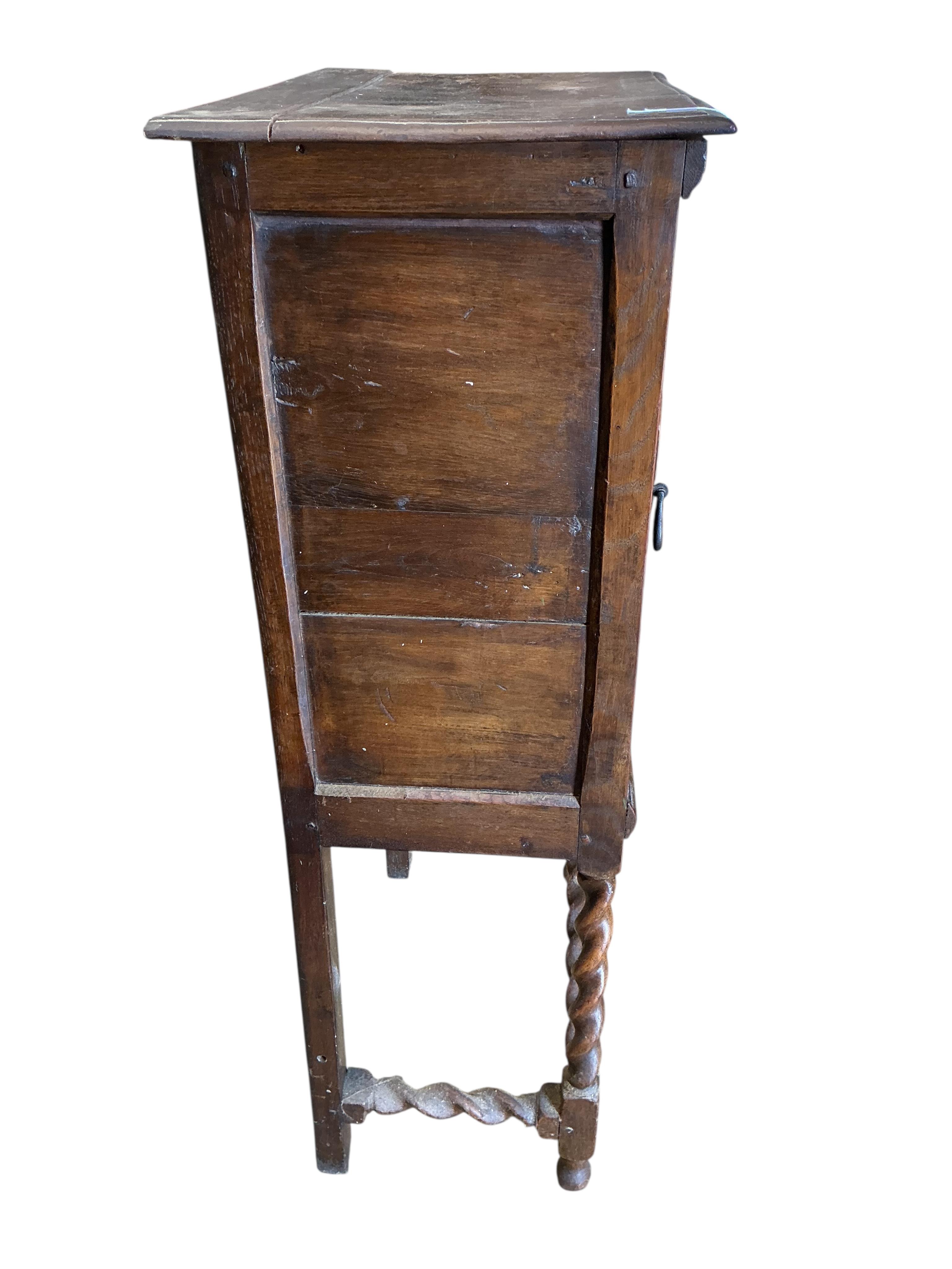 A 17th century style oak cabinet on stand, width 64cm, depth 39cm, height 120cm